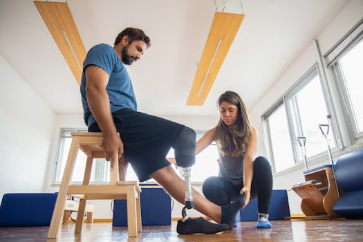 Health and Fitness Team adjusts a patient's sock over their prosthetic leg. The man sits on a stool in the physical therapy Woodbridge NJ office of Health and Fitness Professionals.